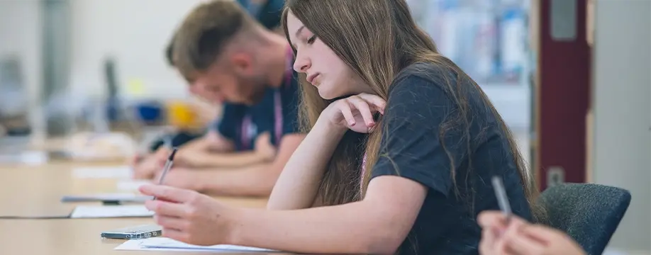 Young apprentices working at a desk 