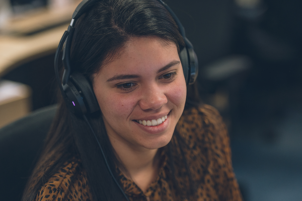 Pelican employee smiling when on a call with a customer
