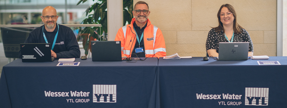YTL UK Careers team sat at Welcome desk smiling