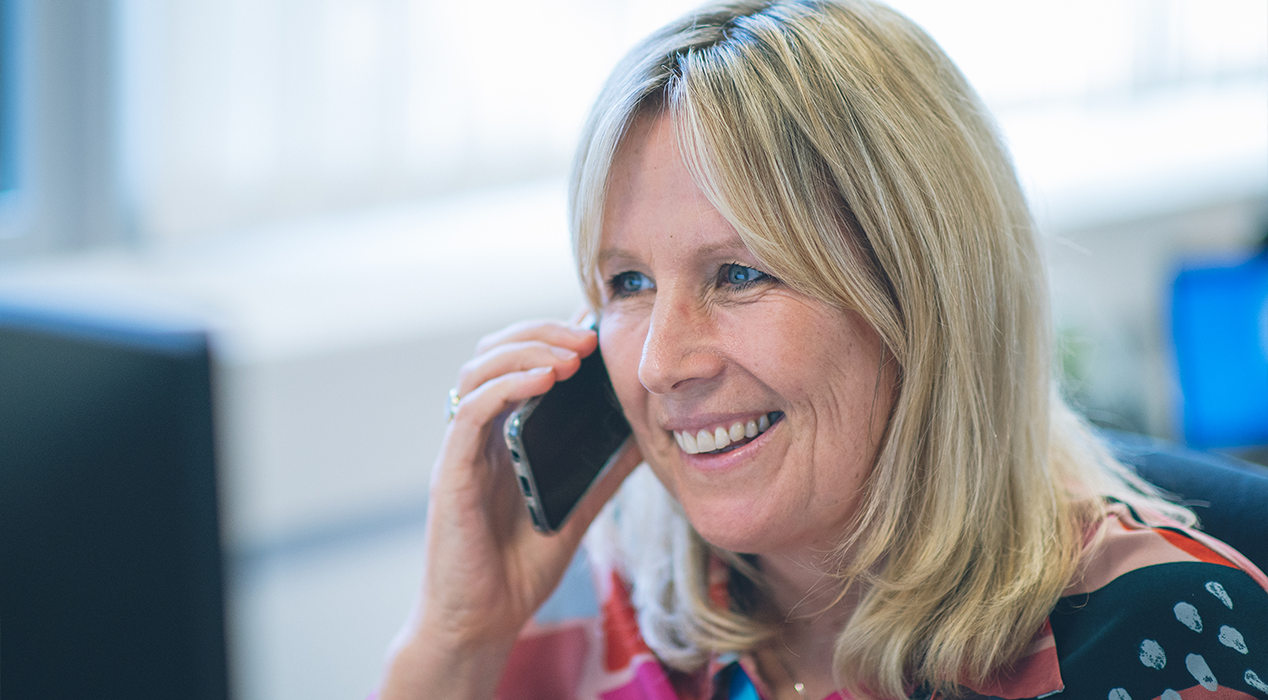 Employee talking and smiling on the phone