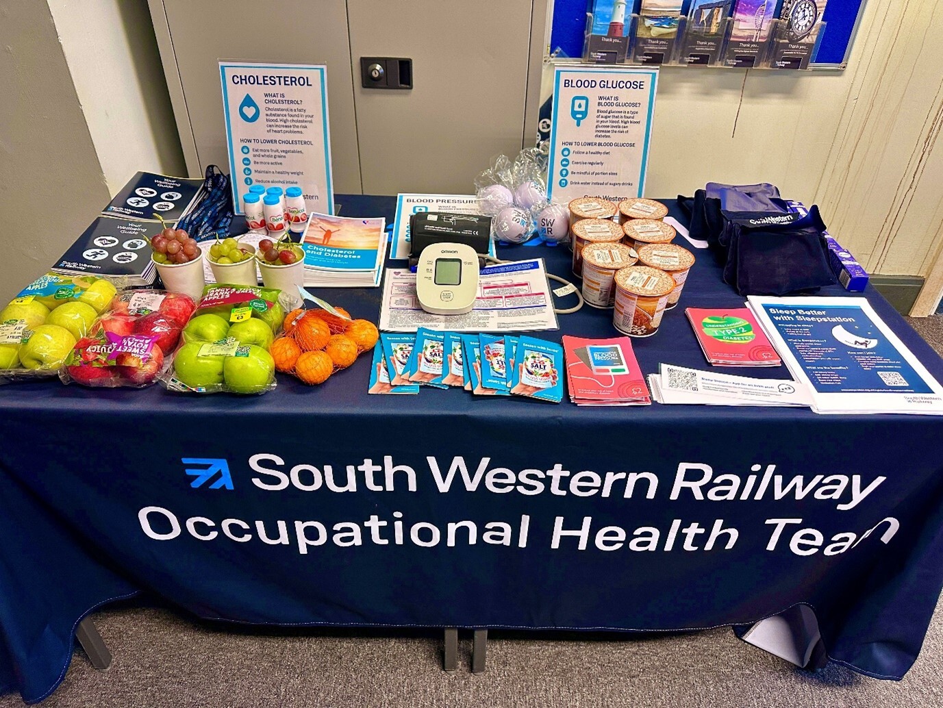 Desk, Cup, Advertisement, Shop, Handbag, Market, Indoors, Poster, Text, People