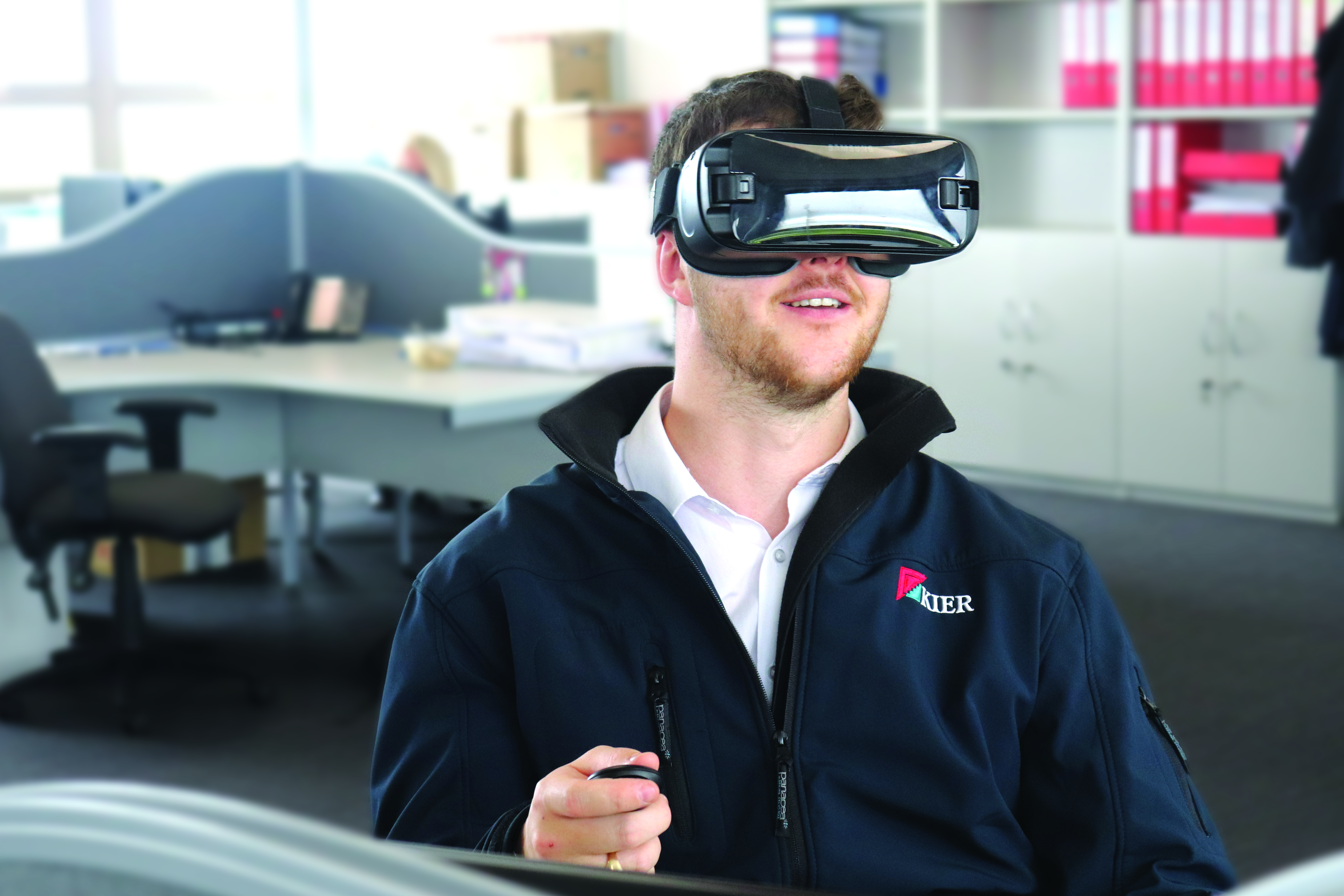 A man sat in an office wearing a virtual reality headset
