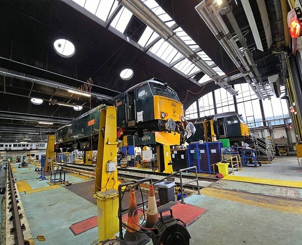 Architecture, Building, Factory, Manufacturing, Workshop, Train, Vehicle, Bag, Handbag, Person