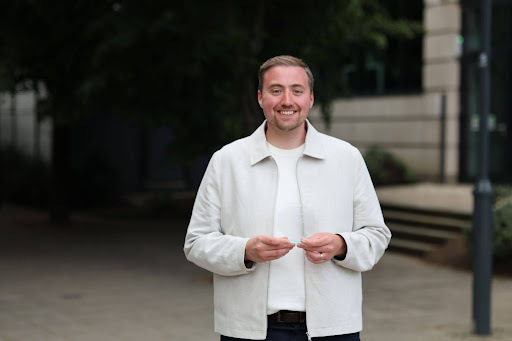 Face, Head, Person, Smile, Blonde, Adult, Male, Man, Standing, Coat