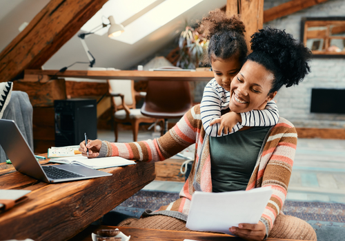 A female colleague workign with her young daughter
