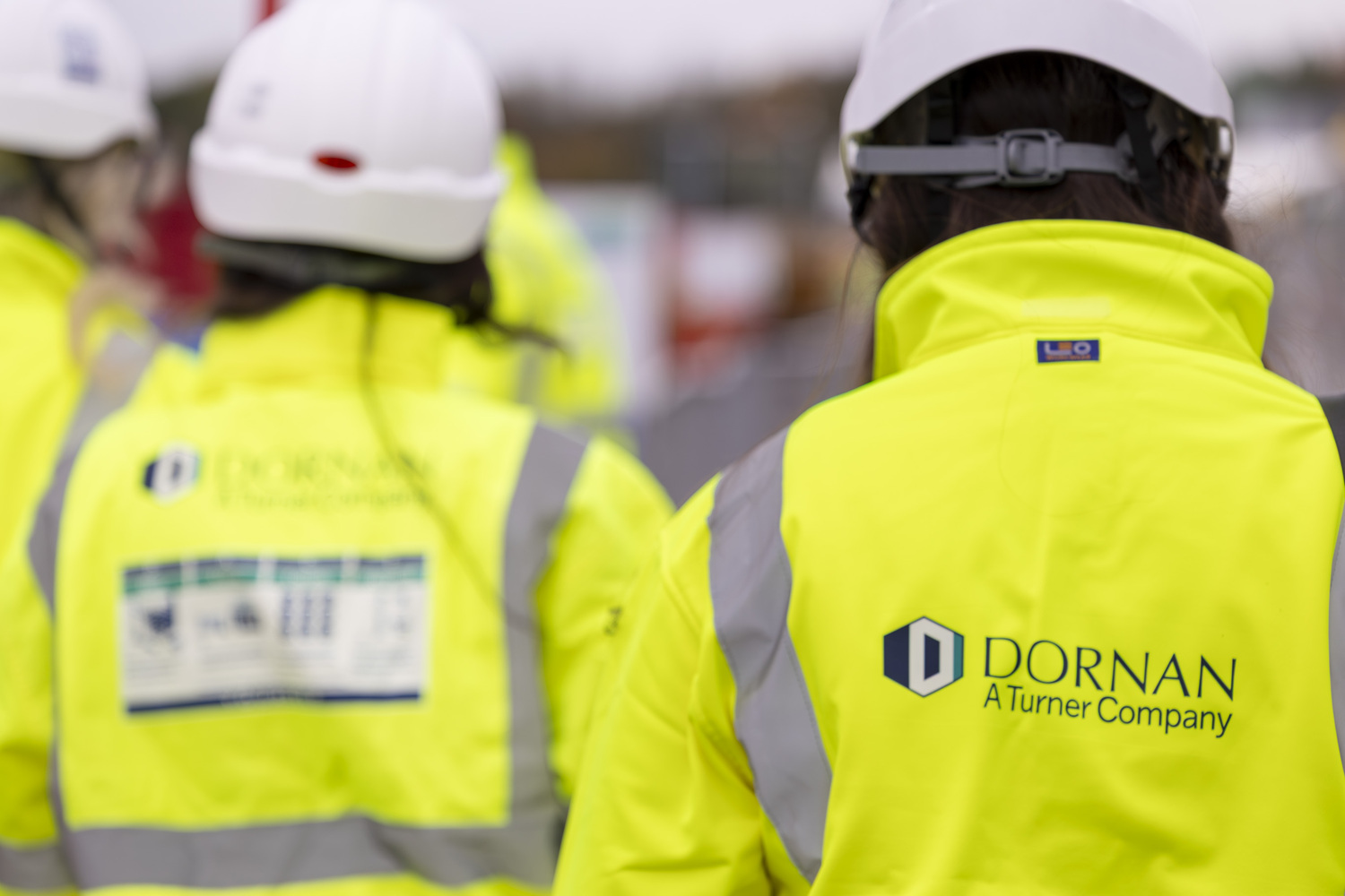 Clothing, Hardhat, Helmet, Coat, Vest, Person, Worker, Lifejacket, Logo, Head