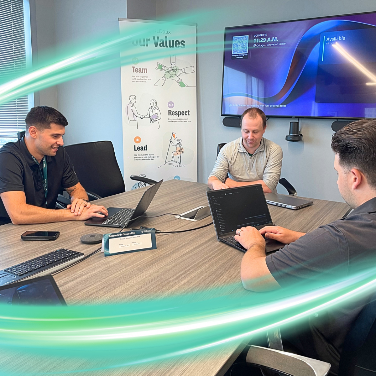 Two women in business clothes are looking at a screen and one is pointing. There is a electric teal and light green neon oval over the photo.