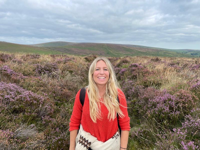 Picture of our Head of Communications, Cherie Willers on a mountain walk in a field of heather