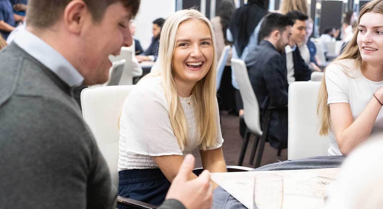 A woman smiling on trainee induction day