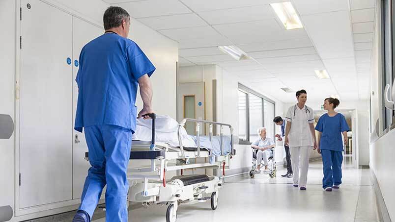 Architecture, Building, Hospital, Person, Clothing, Pajamas, Stretcher